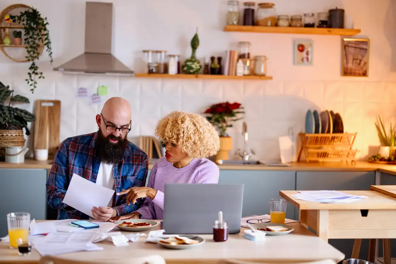A couple going over the numbers at their kitchen table